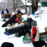 Winter Carnival cardboard sledders line up for race