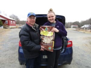Lion Woody Stoddard delivering the donated goods to Marissa Bentley of the Springfield Humane Society.