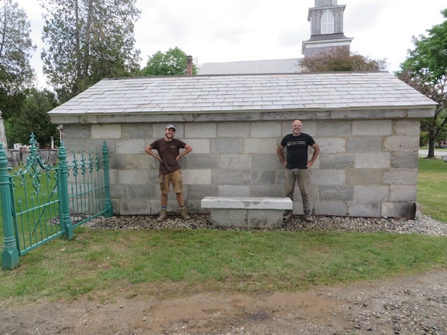 Tuck and Scott Wunderle of Terrigenous Landscape Architecture stand beside the newly installed bench