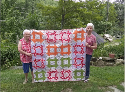 Honorary Ride for the Cure Chair Lois Whidden (right) and volunteer Alice Rogers (left) show off this year's Ride Quilt, donated by Ann M. Ashcroft, of Bellows Falls.