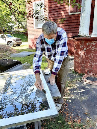 George Keeler repairing windows