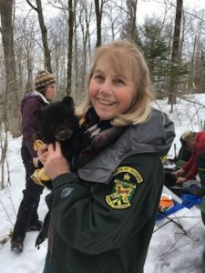 Kim Royar of Vermont Fish & Wildlife with a bear cub