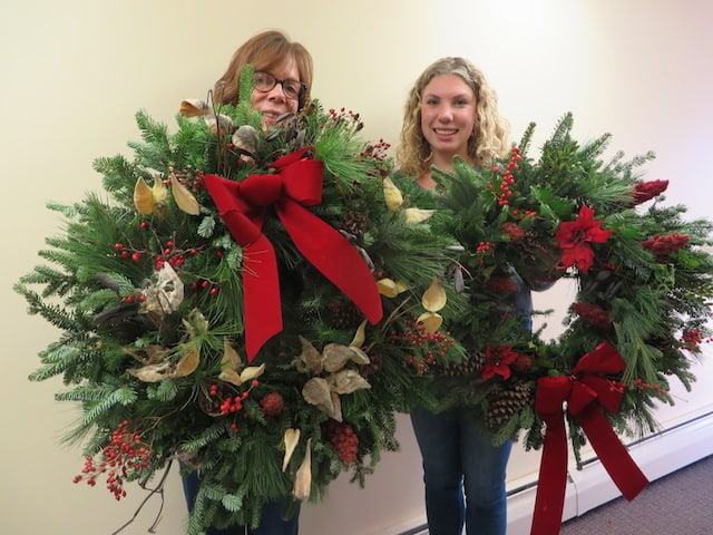 Marilyn Mahusky and Mary Anderson with holiday wreaths made in 2019