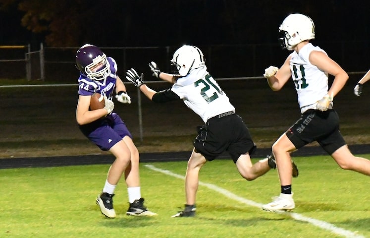 Bellows Falls receiver Jake Moore receives a pass from John Terry during the Terriers 28-24 triumph over archrival Springfield last Friday night. Springfield's defenders were Marshall Simpson (20) and Luke Stocker (11). The Terriers swept the two tight contests last week with Bellows Falls also winning at Springfield 21-14.