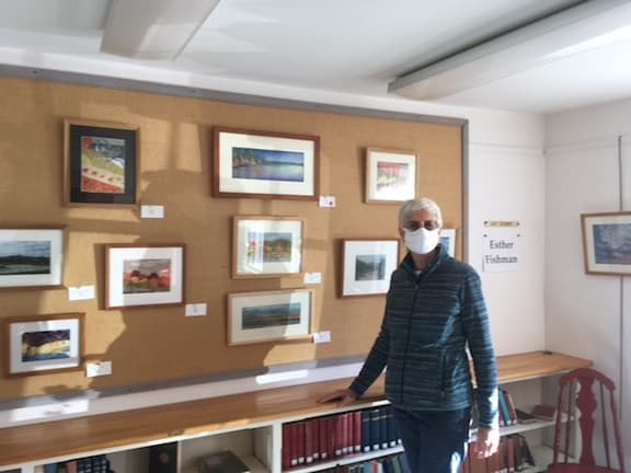 Esther Fishman with her display pastels and collages at the South Londonderry Free Library