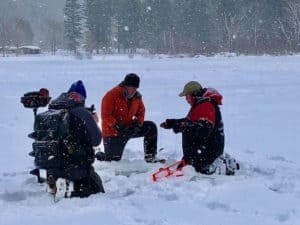 Camera man Matt Rissell and host Tom Richardson from Explore New England film ice fishing guide Matt Trombly