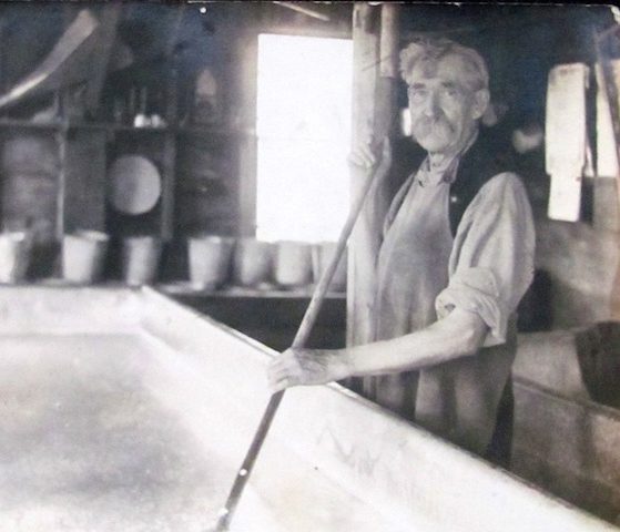 Cheesemaker at Crowley's raking cheese