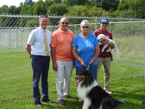 Municipal Manager Scott Murphy, George Thomson, Sue Pollender, and Nick Miele with their four-legged friends at the grand opening of the Ludlow Dog Park. Photo by Sharon Bixby