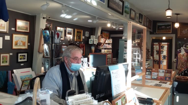 Jeffrey Lessels minding the Walpole Artisan’s Co-op group shop on Main Street in Walpole. Photo by Bill Lockwood