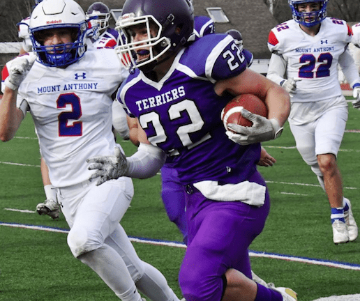 Bellows Falls' Jeb Monier (22) runs the ball down the left side, while Mount Anthony's Gavin Schnoop runs him down during Saturday's Division II championship game at Alumni Field in Rutland. Photo by Doug MacPhee