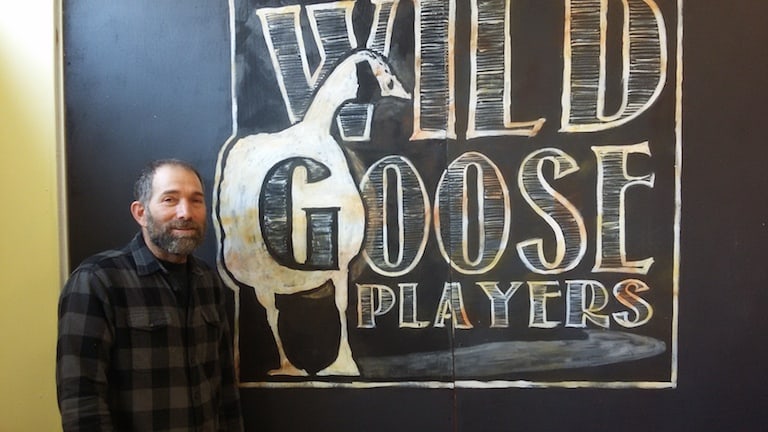 Director David Stern next to his Wild Goose players logo in the group’s new space in Bellows Falls. Photo by Bill Lockwood