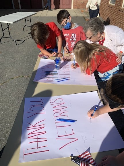 Students sign "Thank You" card to veterans for Veterans Day